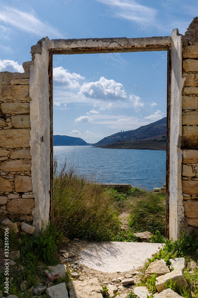 ruins of ancient buildings on the background of the lake and mountains on the island of Cyprus