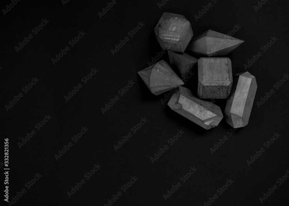 Geometric shapes black and white photography. Black background. Wood pieces