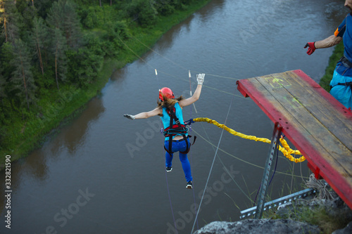 Girl falls from a great height during a jump with a rope, back view. Ropejumping.