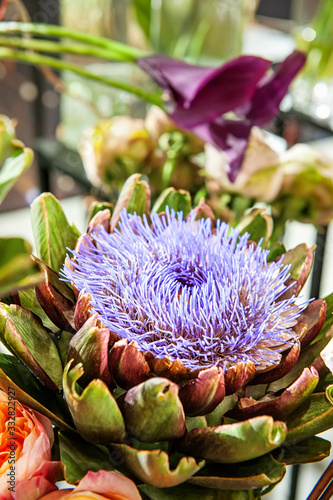 pink artichoke flower Cynara scolymus in a floral arrangement close-up. Selective focus photo