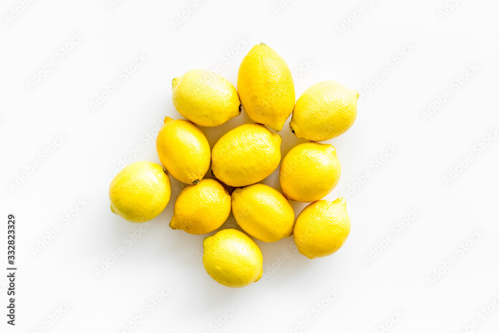 Ripe lemons - whole fruits - on white table top-down copy space