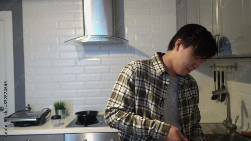 Young sick asian drinking Turkish coffee in kitchen at home Young sick asian drinking Turkish coffee in kitchen at home