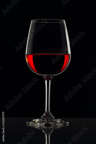 Copa de cristal con fondo negro y bebida de color rojo