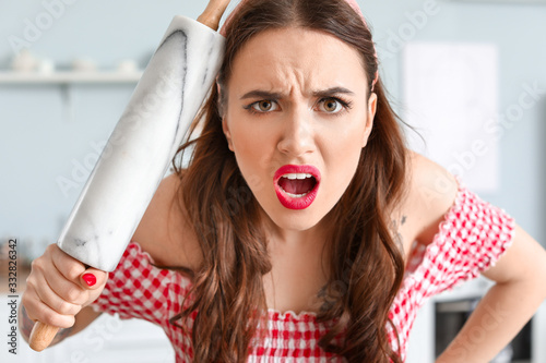 Funny angry housewife in ki...