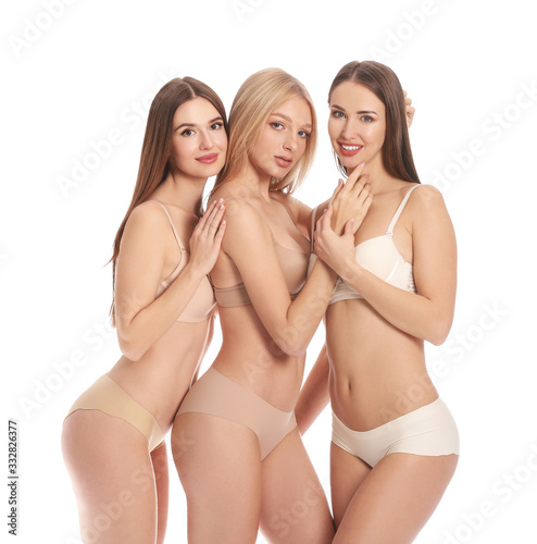 Beautiful young women in underwear on white background © Pixel-Shot