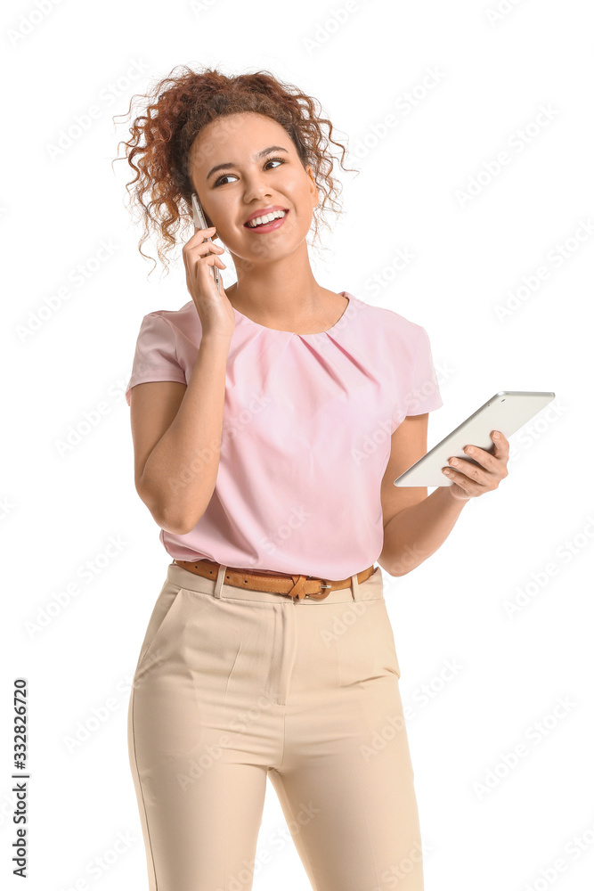 Young African-American businesswoman with tablet computer talking by phone on white background Young African-American businesswoman with tablet computer talking by phone on white background