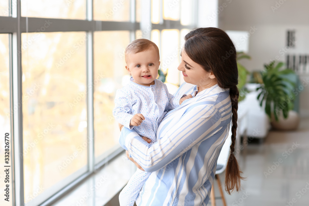 Happy mother with cute little baby near window Happy mother with cute little baby near window