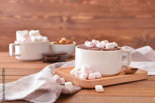 Chocolate mug cake with marshmallows on table