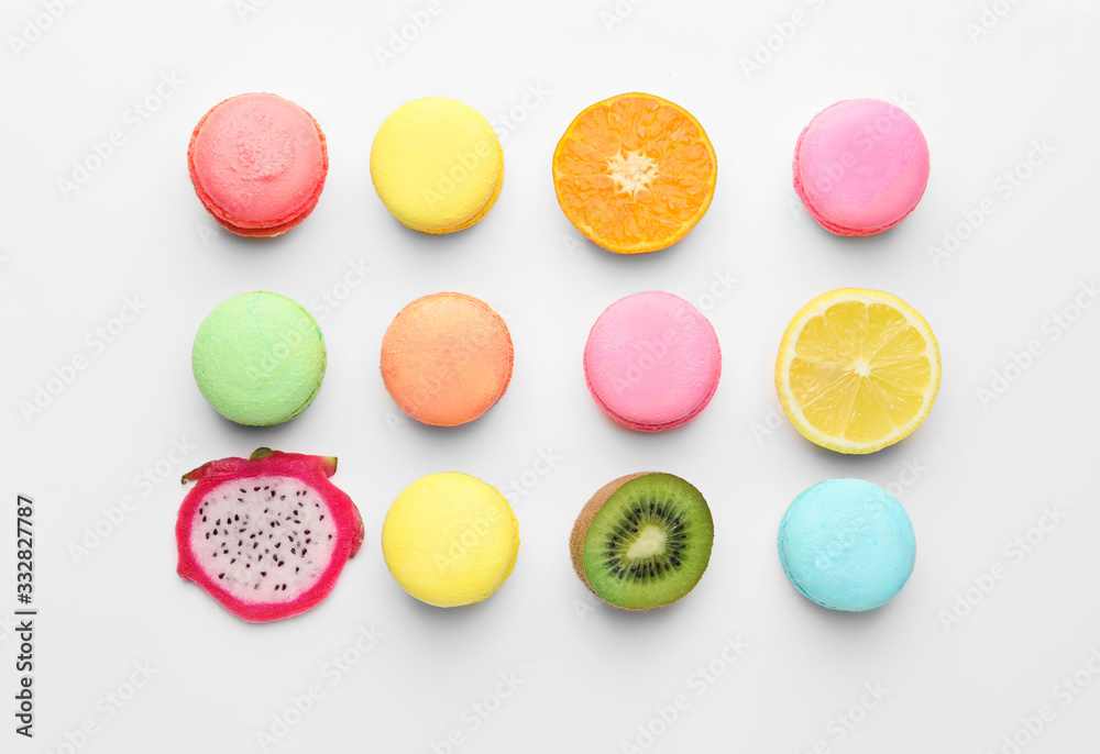 Tasty macarons with fruits on white background Tasty macarons with fruits on white background