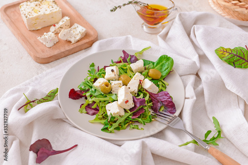 Tasty salad with feta cheese on table