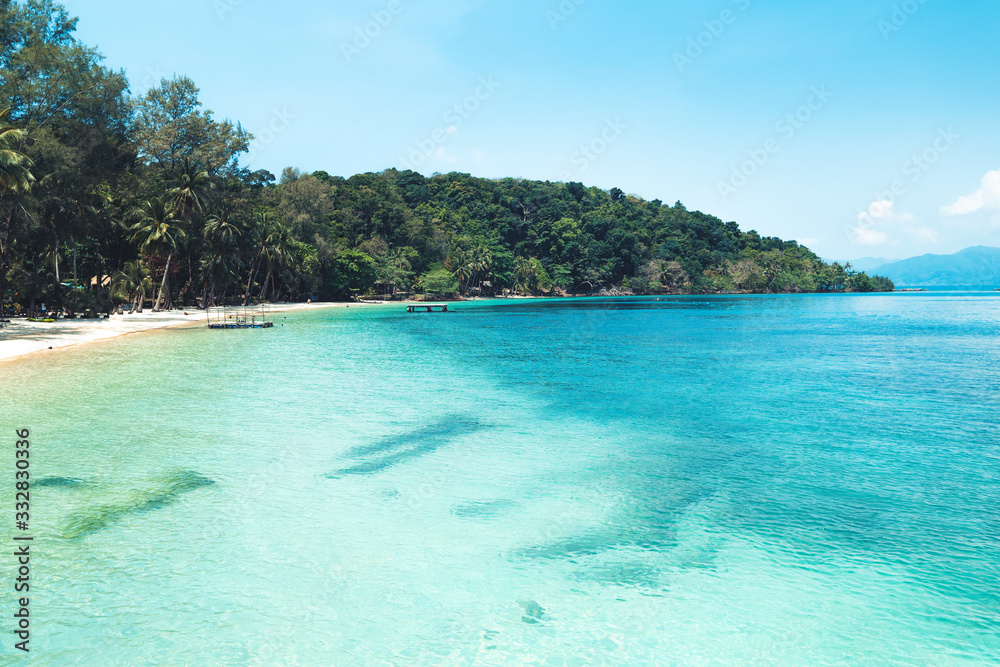 Fototapeta premium Clear water on the island,Bright blue sea and wooden boat The tourism