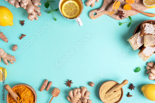 Medical care concept. Cold, flu treatment. Ginger, lemon, honey, pills, drugs, supplements, thermometer on blue background. Natural alternative holistic approach. Top view, copy space