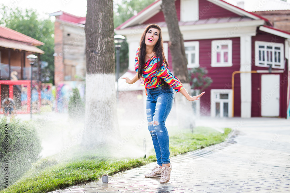 Beautiful attractive young woman having fun and enjoying and dancing in the park on a sunny summer day. Beautiful attractive young woman having fun and enjoying and dancing in the park on a sunny summer day.