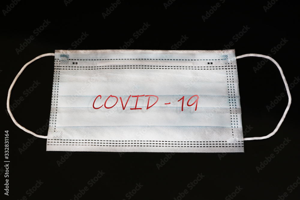 Medical mask on a black background from respiratory illness. Remedy for illness. Coronavirus. Pandemic around the world. Medical mask on a black background from respiratory illness. Remedy for illness. Coronavirus. Pandemic around the world.