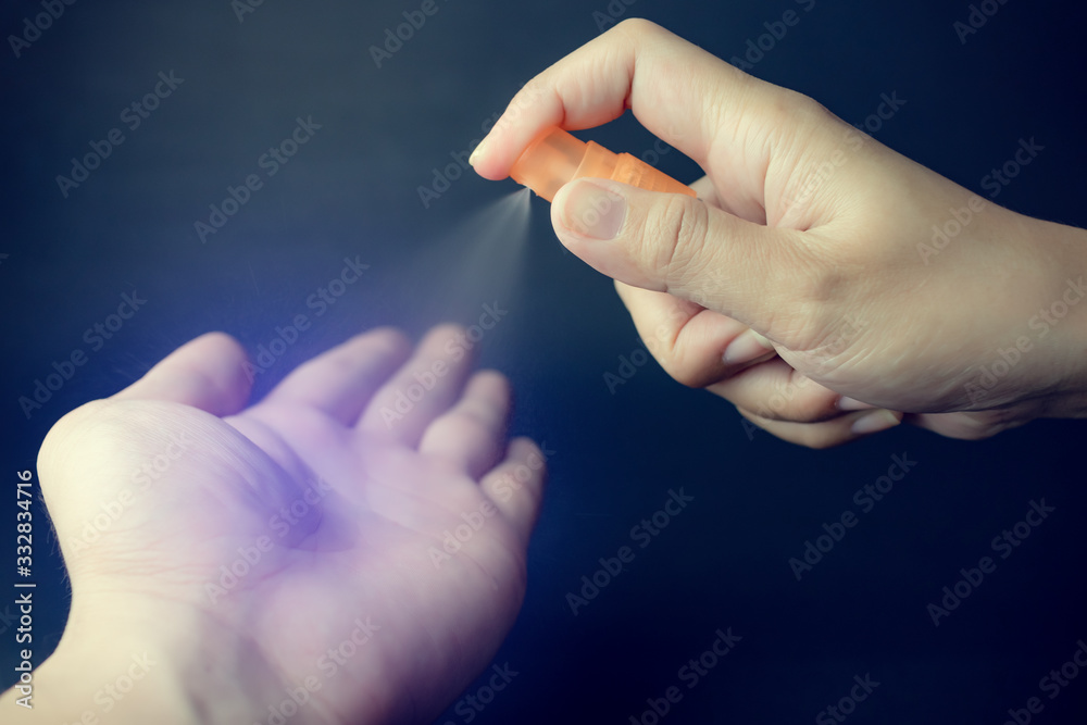 Hand of lady that applying alcohol spray or anti bacteria spray to prevent spread of germs, bacteria and corona virus or COVID-19. Hand of lady that applying alcohol spray or anti bacteria spray to prevent spread of germs, bacteria and corona virus or COVID-19.