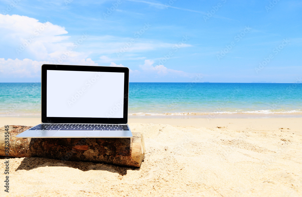 Blank screen laptop On the beach, summertime