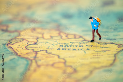 Miniature people: Group of backpacker on vintage world map using as business trip traveler adviser agency or explorer on earth background concept.