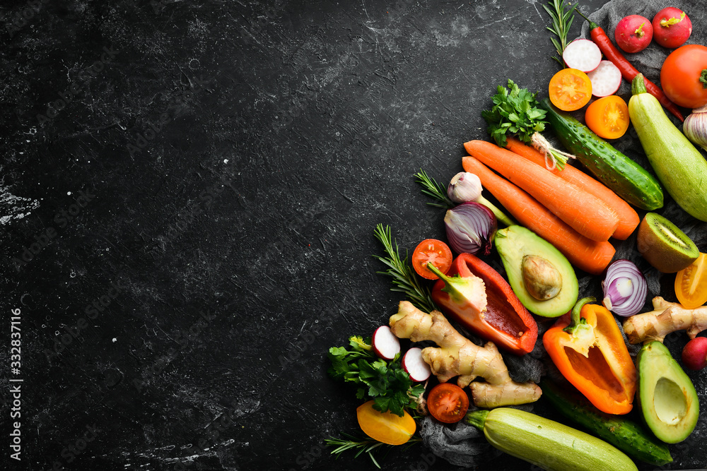 Background of organic food. Fresh vegetables on a dark background. Free space for your text. Rustic style. Background of organic food. Fresh vegetables on a dark background. Free space for your text. Rustic style.
