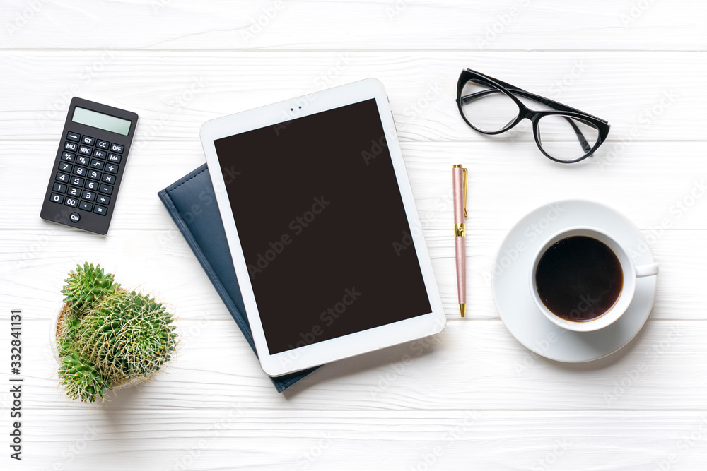 Home office workspace. Tablet, glasses, notepad, cup of coffee, pen, succulent on white wooden background. Top view Business, freelance work concept Mock up Flat lay Home office workspace. Tablet, glasses, notepad, cup of coffee, pen, succulent on white wooden background. Top view Business, freelance work concept Mock up Flat lay