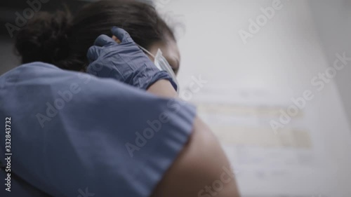 Low angle shot of nurse applying a mask during the coronavirus pandemic. photo