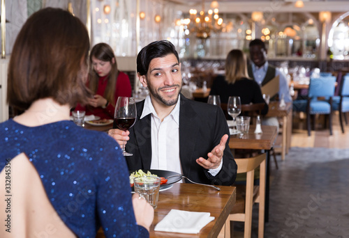 Fototapeta Naklejka Na Ścianę i Meble -  Cheerful man with female in restaurant