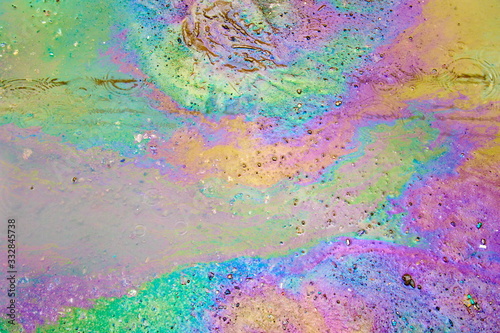 Petrol on the asphalt a big polluted puddle water.