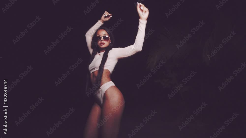 Cute and sexy brunette girl wearing pink long sleeve crop top and panties set and sunglasses dancing, smiling, flirting during summer evening - video in slow motion Cute and sexy brunette girl wearing pink long sleeve crop top and panties set and sunglasses dancing, smiling, flirting during summer evening - video in slow motion