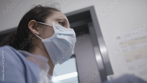 Low angle shot of nurse checking mask during the coronavirus pandemic. photo