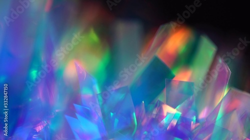 Holographic iridescent tinsel. Hologram Background of abstract shiny foil texture with rainbow colors. Neon pastel gradient of real surface