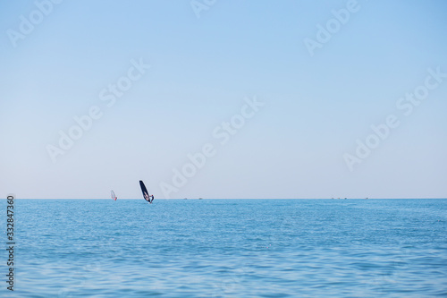 A team of surfers floats on the sea. Windsurfing on the Black Sea coast. Water sports and competitions