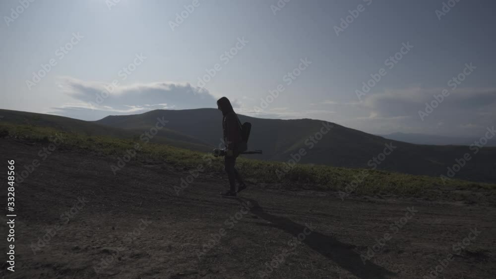 wallking man on top of mountain at sunset wallking man on top of mountain at sunset