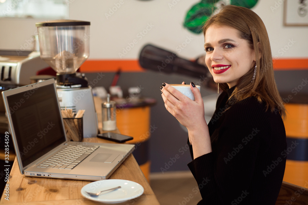 Beautiful Caucasian woman dreaming about something while sitting with portable net-book in modern cafe bar.