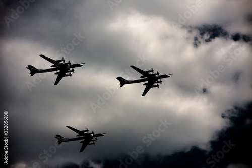 Three bombers fly against the sky in the shadow photo