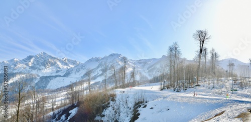 vacationers on the background of peaks in a ski resort © Aleda