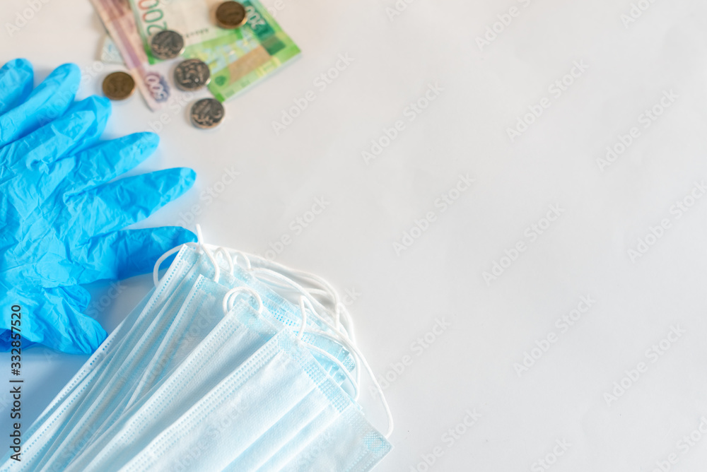 Hand in medical glove is showing protective mask at black background. Coronavirus text on mask. Coronavirus concept. Healthcare concept. Hand in medical glove is showing protective mask at black background. Coronavirus text on mask. Coronavirus concept. Healthcare concept.