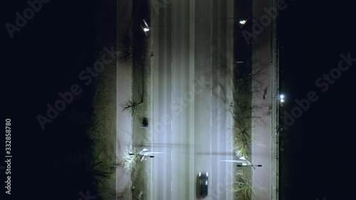 Top view of cars moving by road at night.