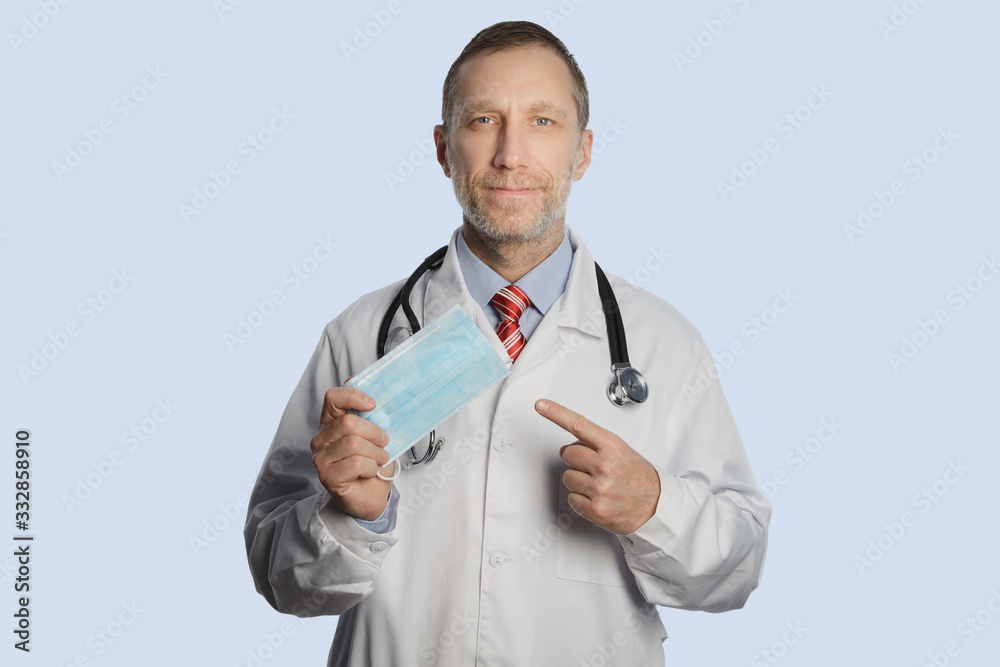Bearded doctor shows a face mask against coronavirus Bearded doctor shows a face mask against coronavirus