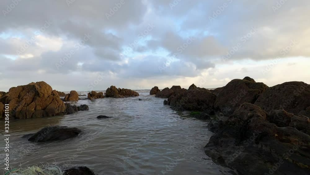 Ocean Water rippling at rocky beach in South Ireland in the evening Ocean Water rippling at rocky beach in South Ireland in the evening