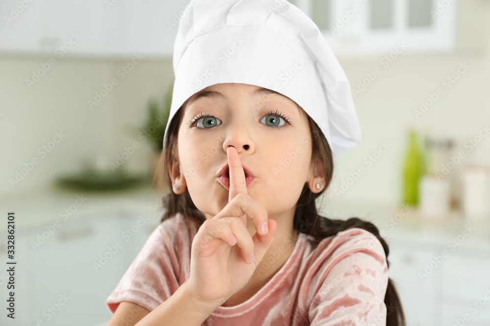 Cute little girl wearing chef hat in kitchen Cute little girl wearing chef hat in kitchen