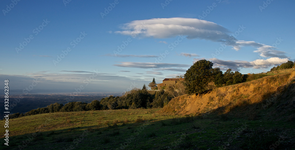 Fototapeta premium Landscape of a meadow with a house in a corner