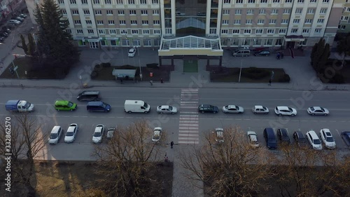 Top view of pedestrian crossing and passing cars.
