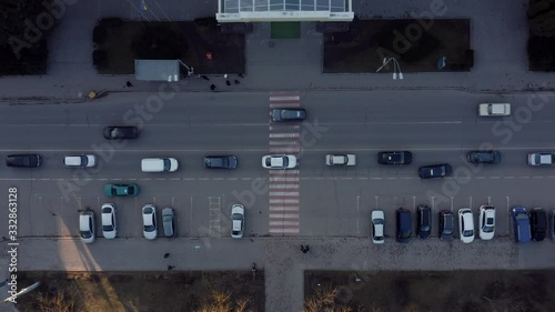 Top view of pedestrian crossing and passing cars.