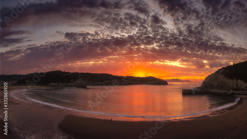 A colorful sunset with the hole view of the bay and beach of Gorliz  Euskadi . Big horizontal panorama.