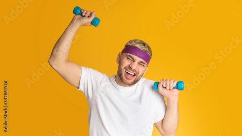 Funny man hard to do exercises with dumbbells