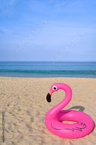 Flamingo shape, floating rubber ring by the beach © niradj