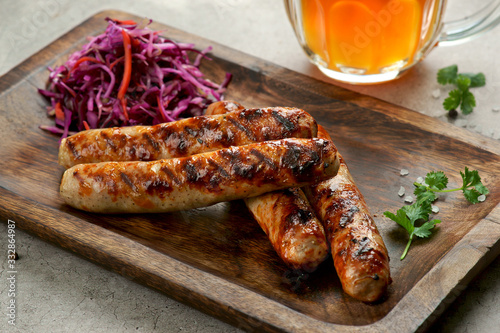 grilled sausages with Cole slaw salad and a glass of beer