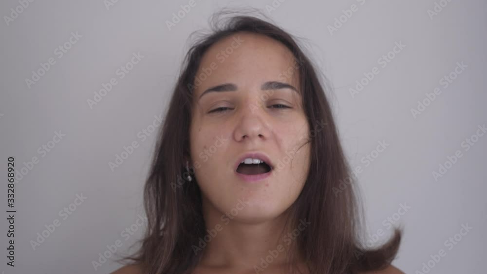 Young woman takes off medical mask, breathes deeply, smiling and looks at camera. Young woman takes off medical mask, breathes deeply, smiling and looks at camera.