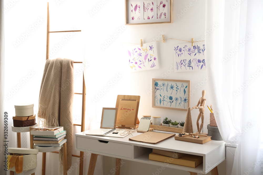 Fototapeta premium Stylish room interior with creative workplace near white wall