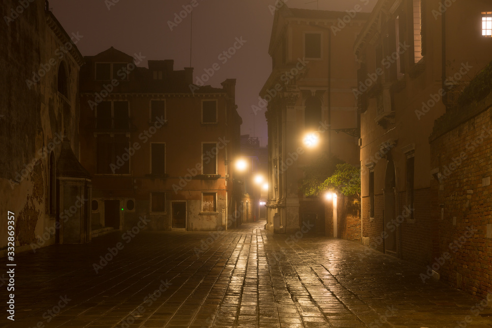 Venice street without people with night fog, Italy