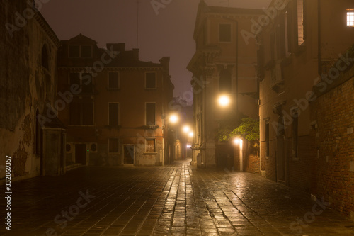 Venice street without people with night fog  Italy